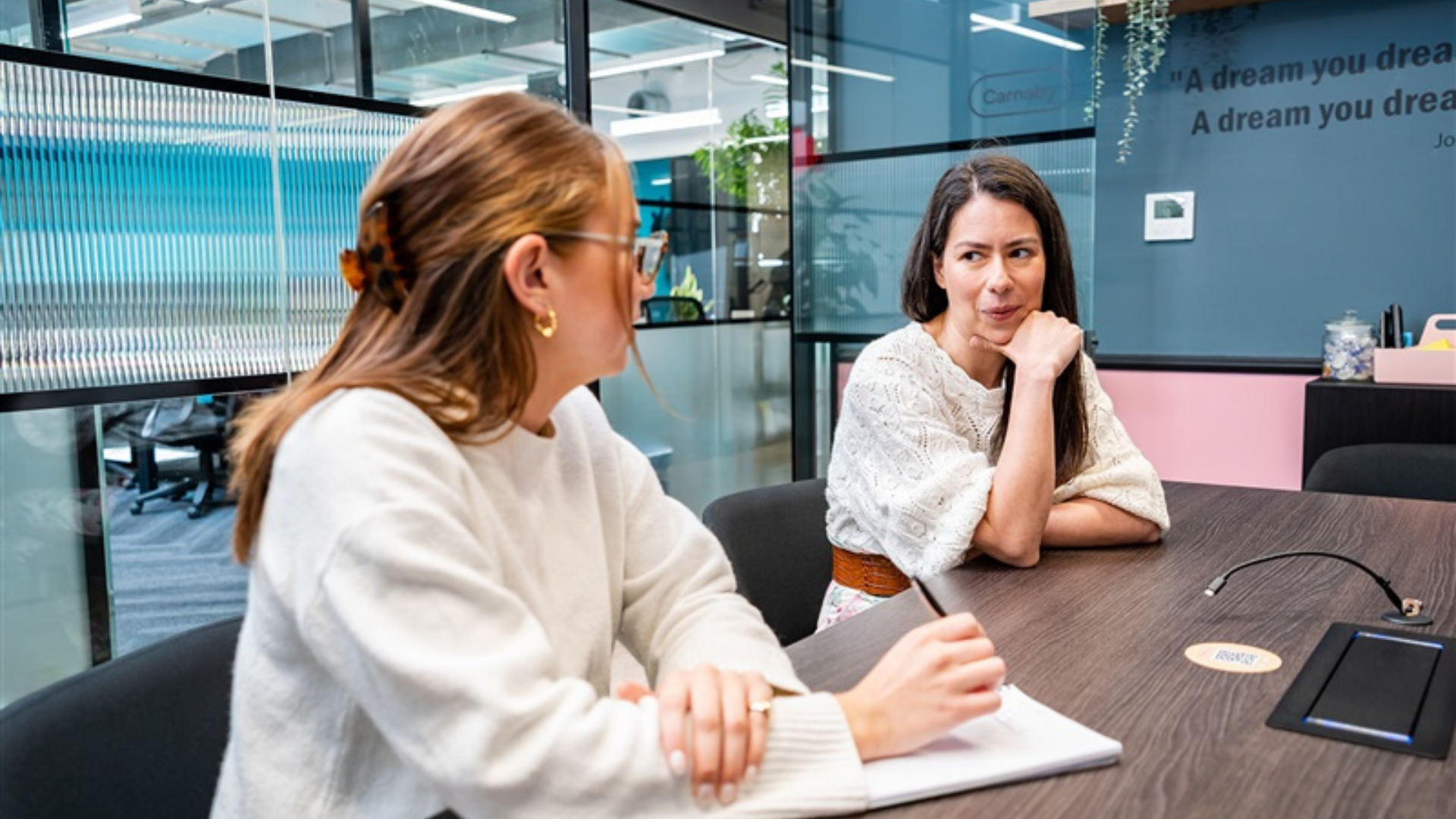 Two women talking in a meeting
