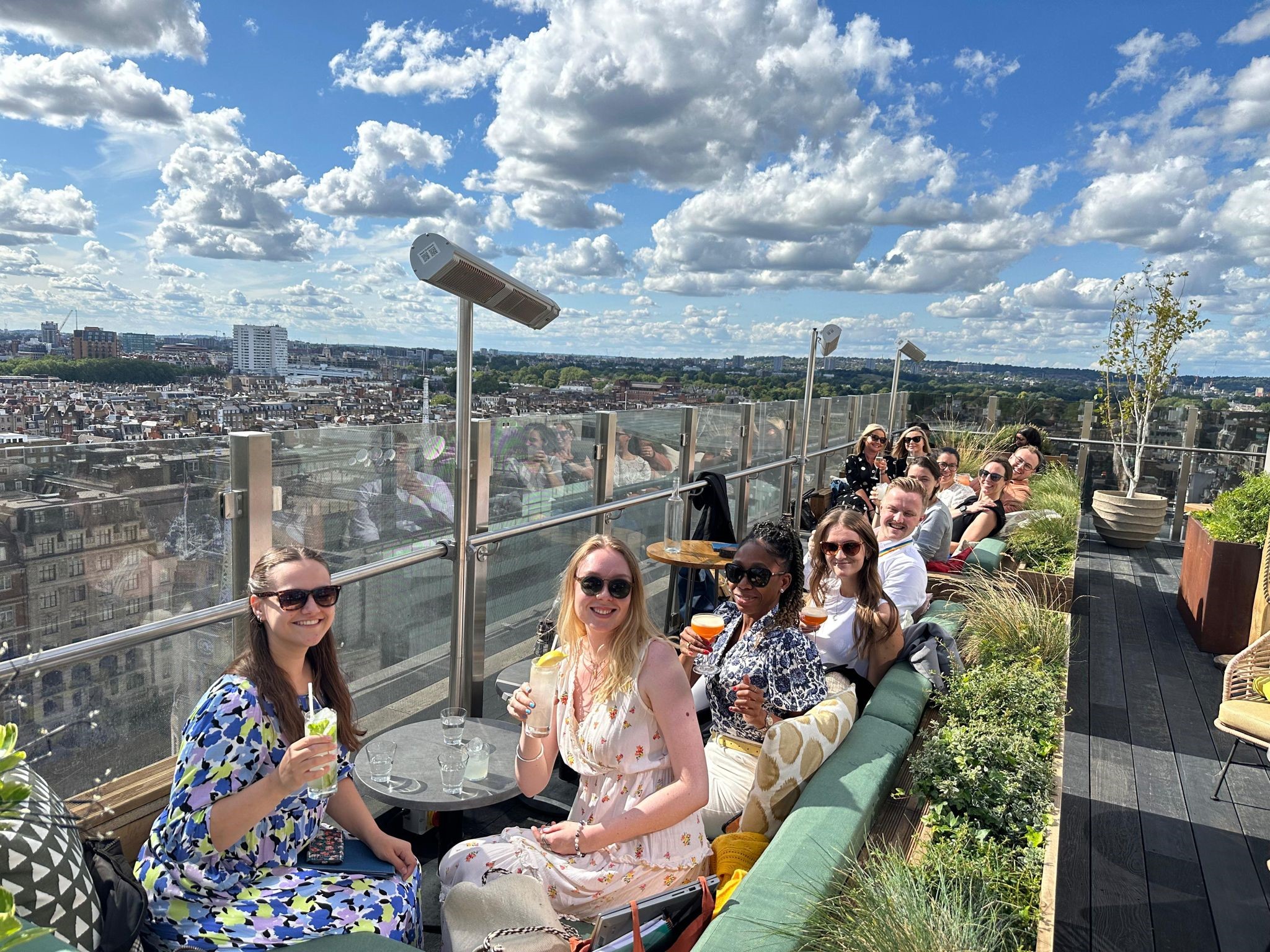Social image of the ISE team having drinks on a rooftop 