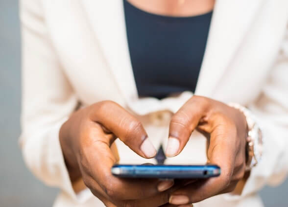 Woman typing on a mobile phone