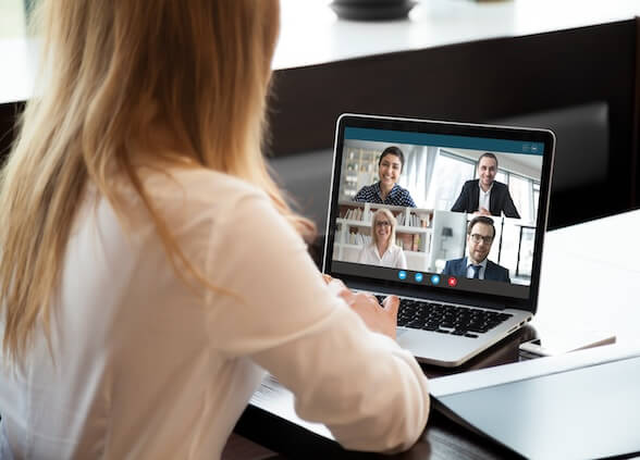 Woman in a virtual meeting in a laptop