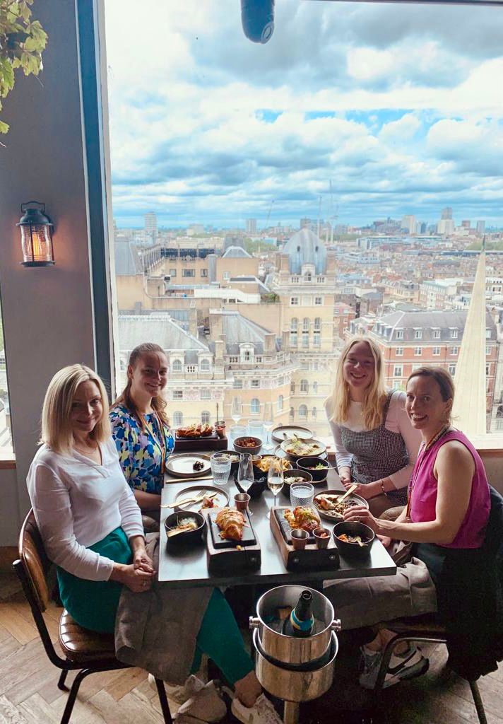 Four employees enjoying a celebratory lunch 