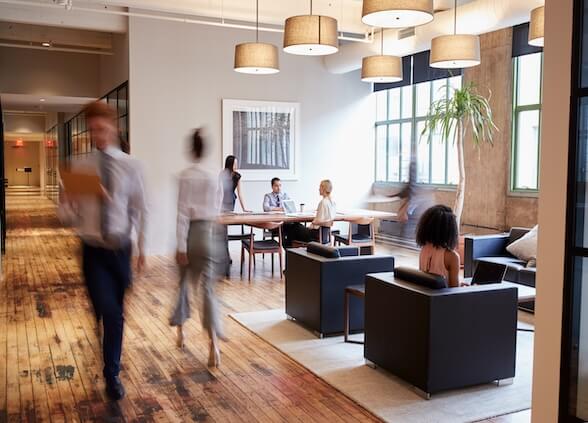 Modern office with people walking by